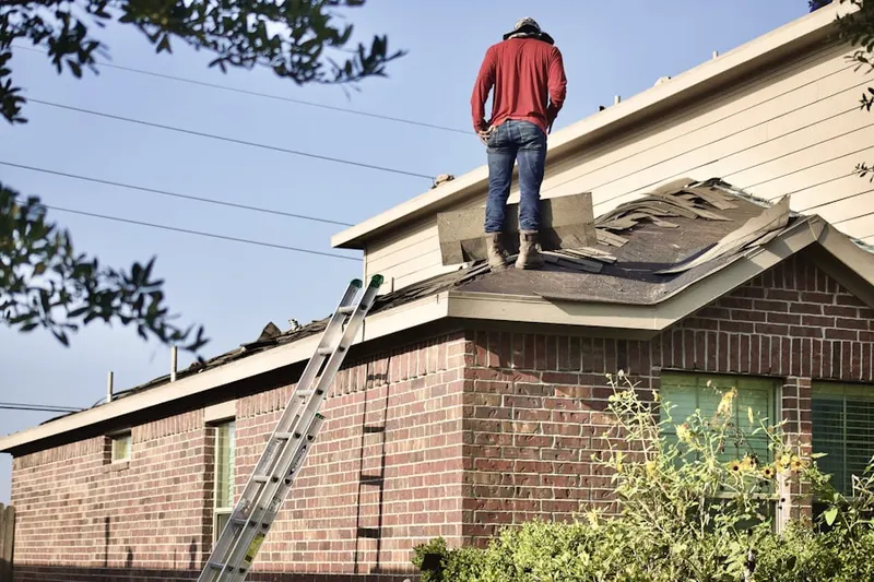 Professional roofer working on a residential roof in Quail Creek